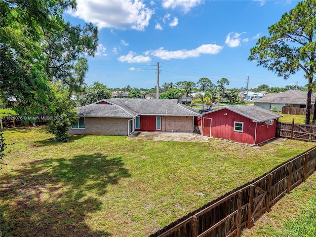 1482 SE Manth Ln, Port St Lucie, FL 34983 - rear view of property featuring brick siding, a patio area, a fenced backyard, and roof with shingles
