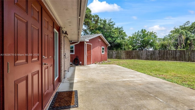 1482 SE Manth Ln, Port St Lucie, FL 34983 - fenced backyard featuring a patio and an outbuilding