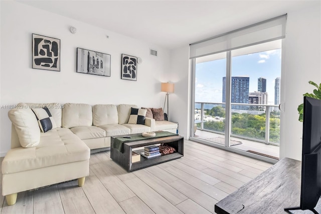 4250 Biscayne Blvd Unit 1217, Miami, FL 33137 - living area featuring a wall of windows and light wood-style flooring
