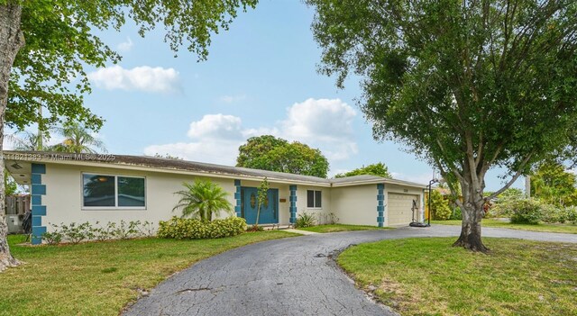 1321 NW 75th Ter, Plantation, FL 33313 - single story home with a garage, stucco siding, driveway, and a front lawn