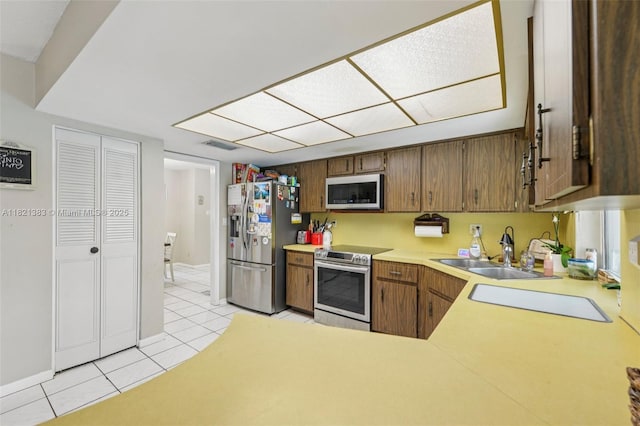 1321 NW 75th Ter, Plantation, FL 33313 - kitchen featuring stainless steel appliances, light tile patterned floors, and light countertops