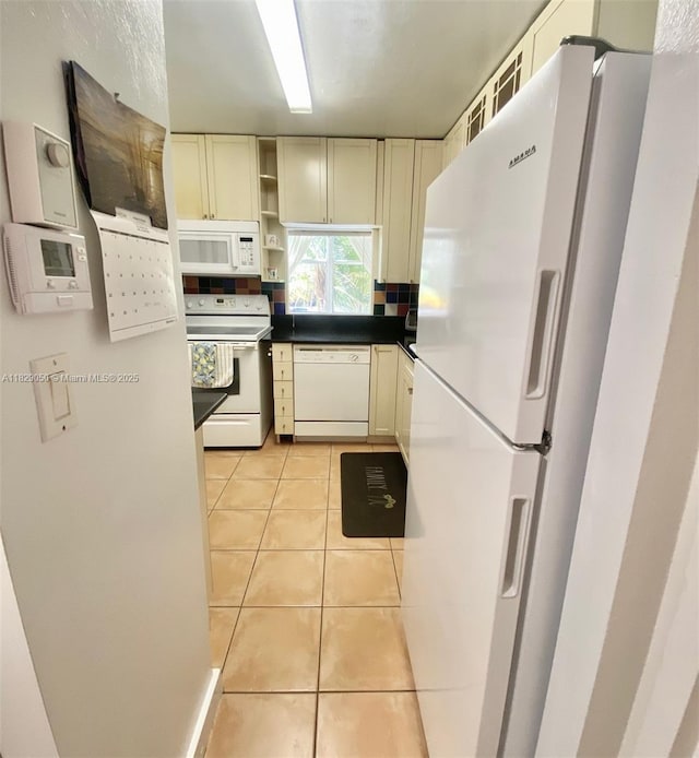 210 172nd St Unit 226, Sunny Isles Beach, FL 33160 - kitchen featuring white appliances, light tile patterned floors, open shelves, dark countertops, and decorative backsplash
