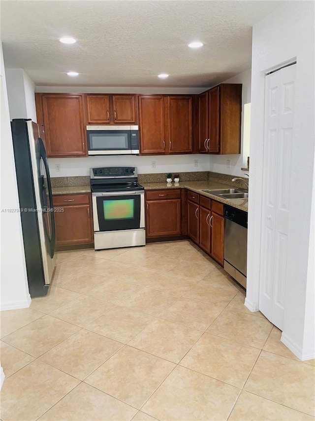 5907 Glasgow Way, Tamarac, FL 33321 - kitchen with appliances with stainless steel finishes, recessed lighting, a textured ceiling, and light tile patterned floors