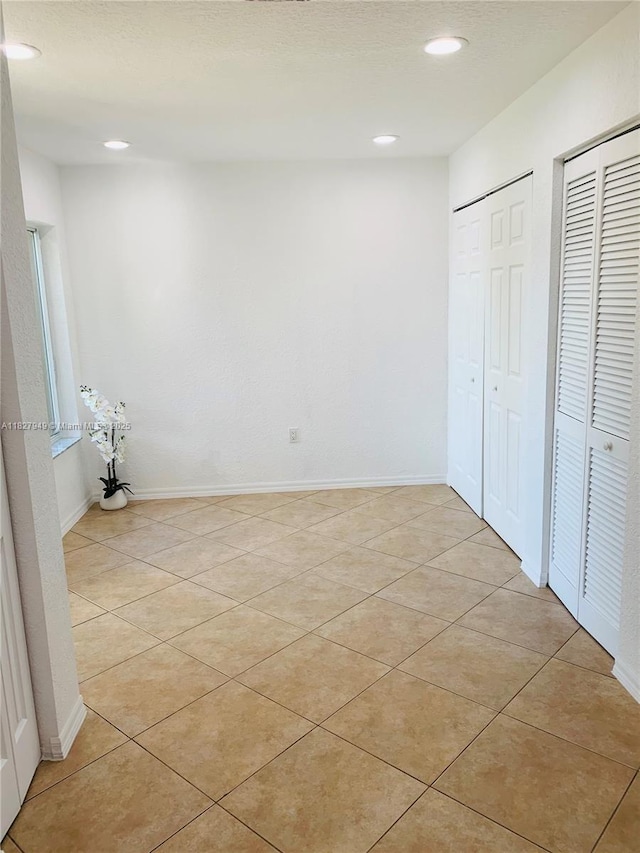 5907 Glasgow Way, Tamarac, FL 33321 - unfurnished bedroom with multiple closets, recessed lighting, and light tile patterned floors