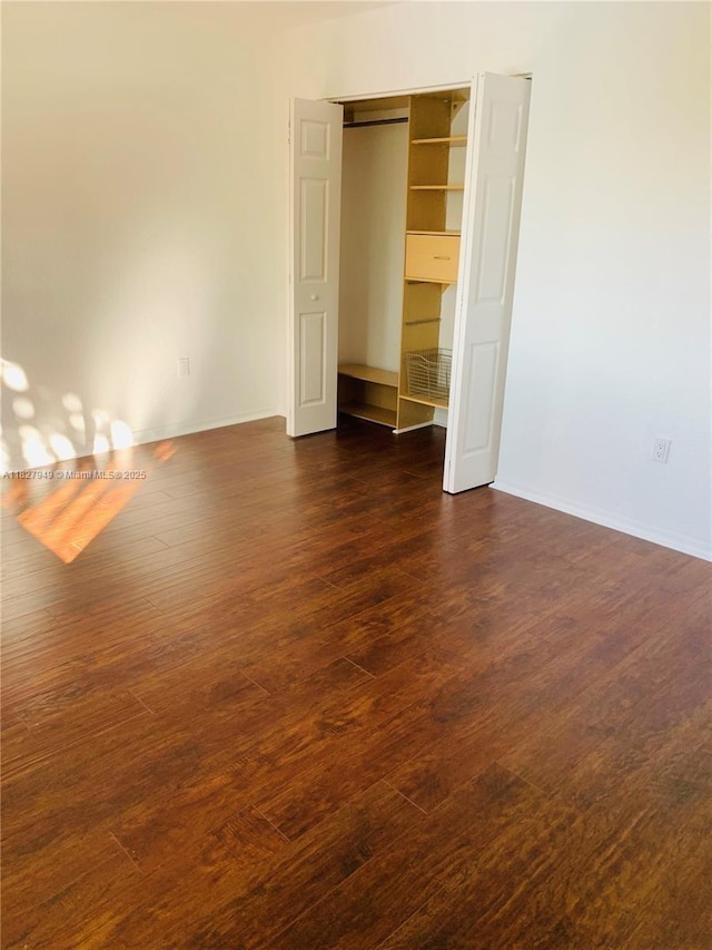 5907 Glasgow Way, Tamarac, FL 33321 - unfurnished bedroom with dark wood-style floors and a closet