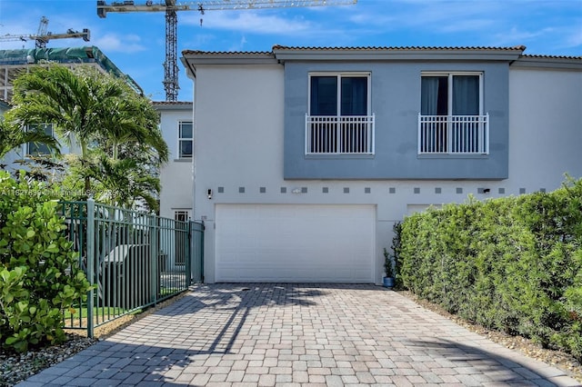 1110 SE 4th Ave, Fort Lauderdale, FL 33316 - view of front of house with an attached garage, stucco siding, decorative driveway, and a tile roof