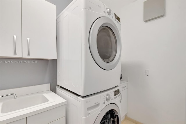 1110 SE 4th Ave, Fort Lauderdale, FL 33316 - laundry room featuring stacked washer / dryer and cabinet space