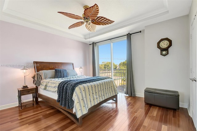 1110 SE 4th Ave, Fort Lauderdale, FL 33316 - bedroom featuring a tray ceiling, access to exterior, wood finished floors, crown molding, and a ceiling fan
