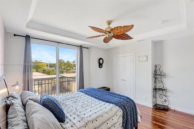 1110 SE 4th Ave, Fort Lauderdale, FL 33316 - bedroom featuring a tray ceiling, access to exterior, wood finished floors, a closet, and ceiling fan