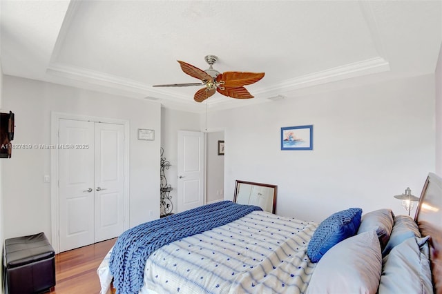 1110 SE 4th Ave, Fort Lauderdale, FL 33316 - bedroom featuring a tray ceiling, wood finished floors, a closet, crown molding, and ceiling fan