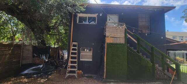 279 NW 54th St, Miami, FL 33127 - back of house with stucco siding and stairs