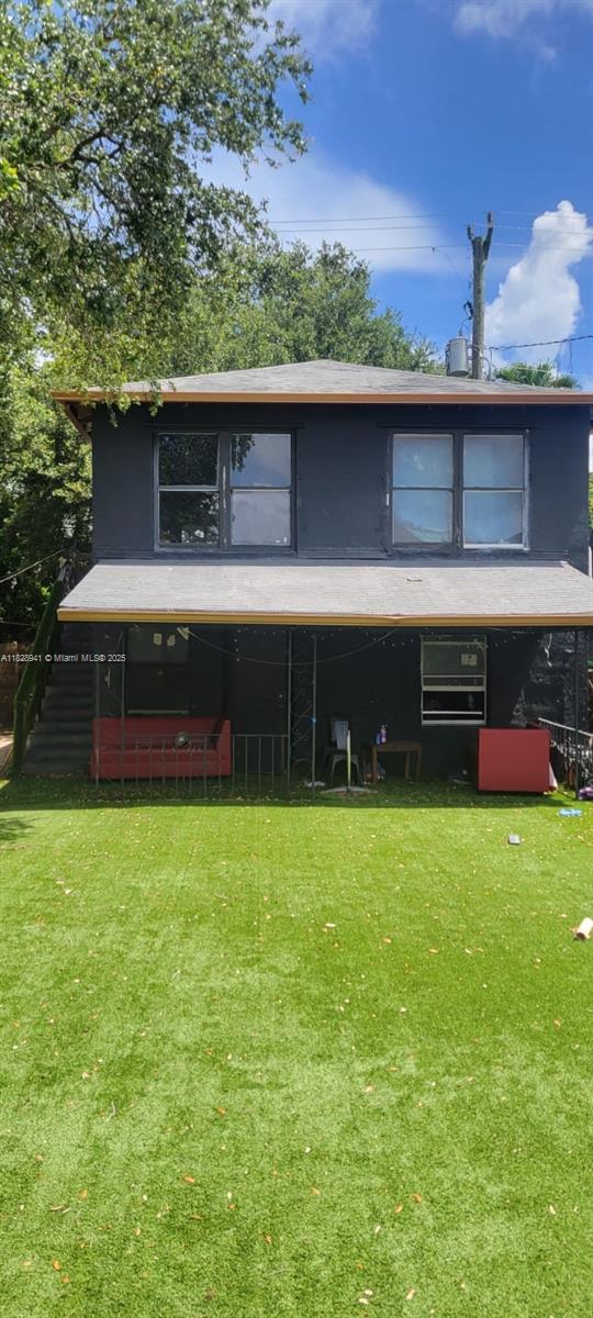 279 NW 54th St, Miami, FL 33127 - back of property featuring a lawn