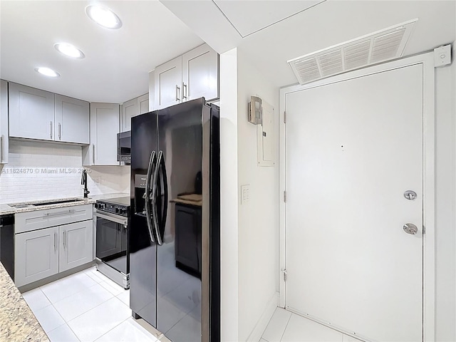 101 E Mcnab Rd Unit 311, Pompano Beach, FL 33060 - kitchen featuring black refrigerator with ice dispenser, gray cabinetry, light tile patterned floors, recessed lighting, and backsplash