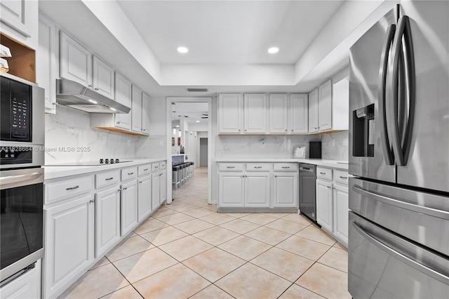 16400 SW 80th Ave, Palmetto Bay, FL 33157 - kitchen with stainless steel appliances, light countertops, light tile patterned floors, under cabinet range hood, and recessed lighting