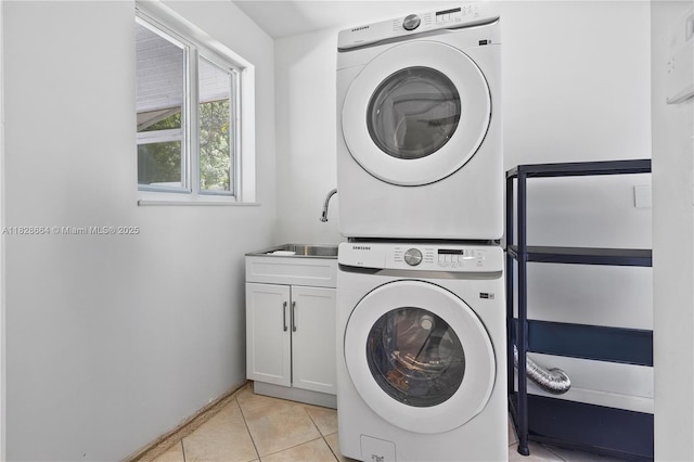 16400 SW 80th Ave, Palmetto Bay, FL 33157 - laundry area with stacked washer / drying machine, cabinet space, and light tile patterned floors