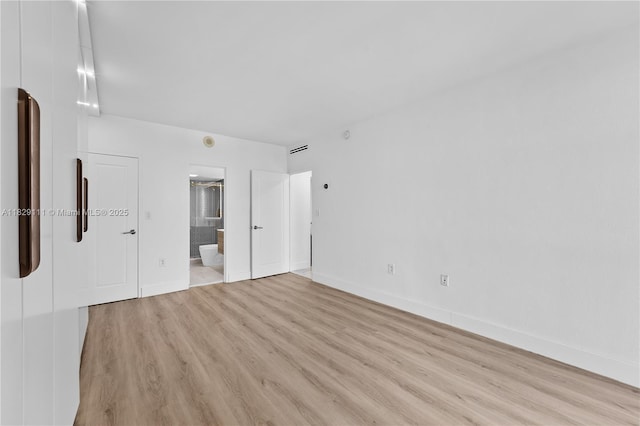 10275 Collins Ave Unit 1035, Bal Harbour, FL 33154 - unfurnished bedroom featuring light wood-style flooring and ensuite bathroom