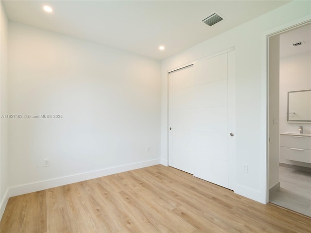 2107 SW 18th Ave, Fort Lauderdale, FL 33315 - unfurnished bedroom with light wood-style flooring, recessed lighting, and a closet