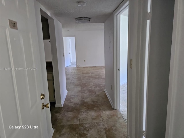 907 NE 199th St Unit 106, Miami, FL 33179 - corridor with a textured ceiling and baseboards