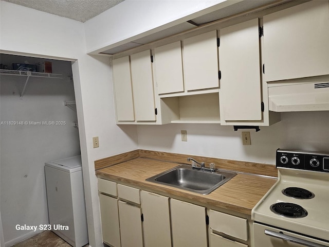 907 NE 199th St Unit 106, Miami, FL 33179 - kitchen featuring electric range, under cabinet range hood, washer / clothes dryer, white cabinetry, and light countertops