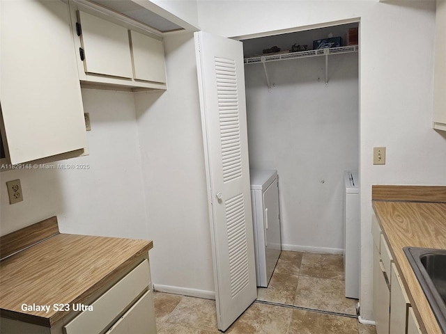 907 NE 199th St Unit 106, Miami, FL 33179 - washroom with washing machine and clothes dryer and baseboards