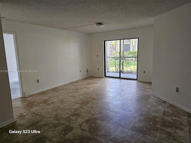 907 NE 199th St Unit 106, Miami, FL 33179 - empty room with baseboards and a textured ceiling