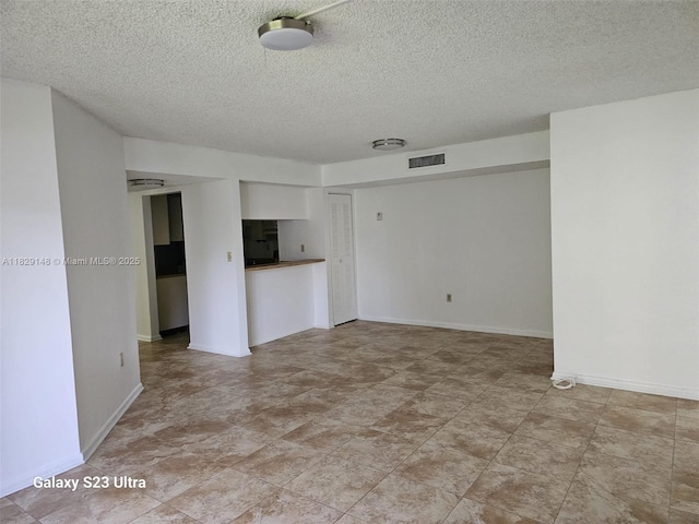 907 NE 199th St Unit 106, Miami, FL 33179 - empty room featuring a textured ceiling and baseboards