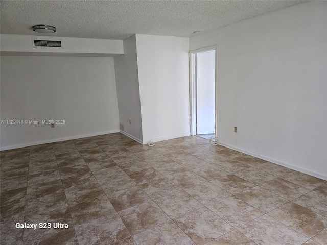 907 NE 199th St Unit 106, Miami, FL 33179 - unfurnished room with a textured ceiling and baseboards