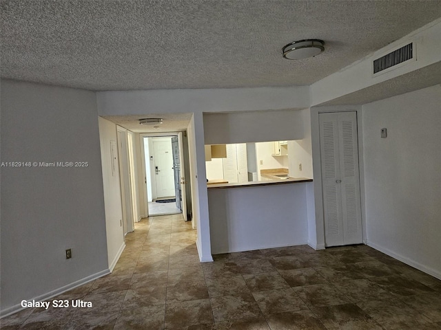 907 NE 199th St Unit 106, Miami, FL 33179 - empty room with baseboards and a textured ceiling