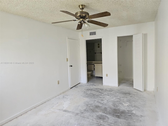 907 NE 199th St Unit 106, Miami, FL 33179 - unfurnished bedroom with concrete floors, ensuite bath, a textured ceiling, and ceiling fan