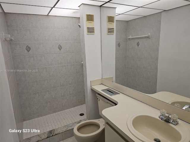 907 NE 199th St Unit 106, Miami, FL 33179 - bathroom featuring tiled shower, vanity, and a drop ceiling