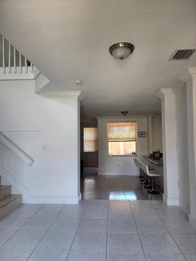 10878 NW 51st Ln, Doral, FL 33178 - hall featuring tile patterned floors, crown molding, and stairs