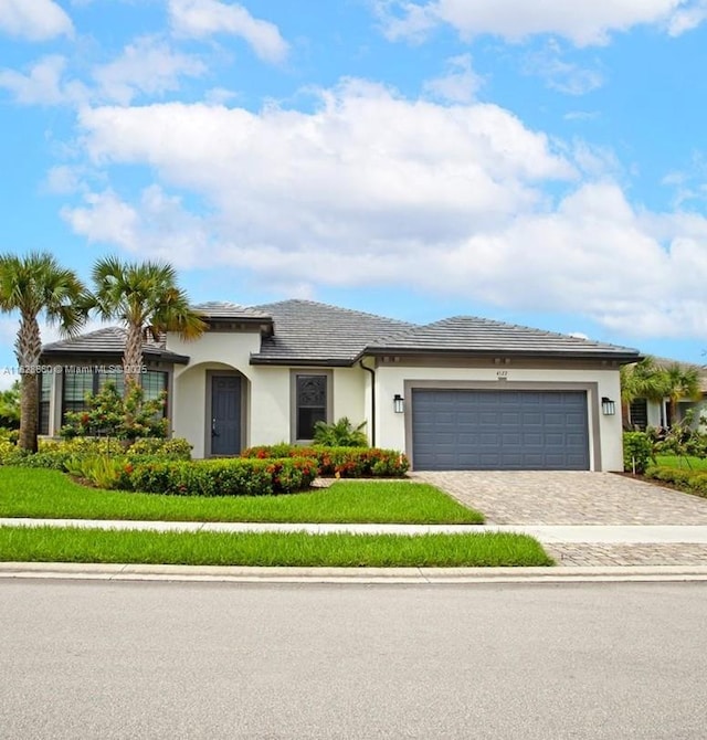 4527 Blessed Place Dr, Oakland Park, FL 33309 - view of front of property featuring decorative driveway, a garage, and stucco siding