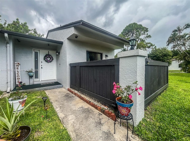 61 W Seminole Ct W, Royal Palm Beach, FL 33411 - view of exterior entry featuring stucco siding