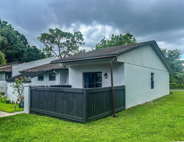 61 W Seminole Ct W, Royal Palm Beach, FL 33411 - rear view of house with a yard, stucco siding, and a shingled roof
