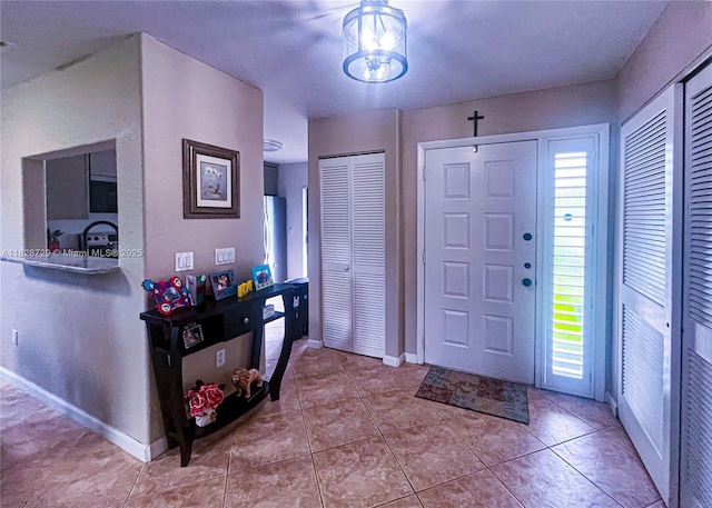 61 W Seminole Ct W, Royal Palm Beach, FL 33411 - tiled foyer entrance featuring baseboards