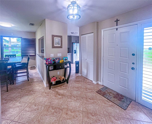 61 W Seminole Ct W, Royal Palm Beach, FL 33411 - foyer entrance with light tile patterned floors and baseboards