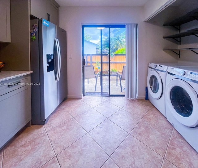 61 W Seminole Ct W, Royal Palm Beach, FL 33411 - washroom with washer and dryer and light tile patterned flooring