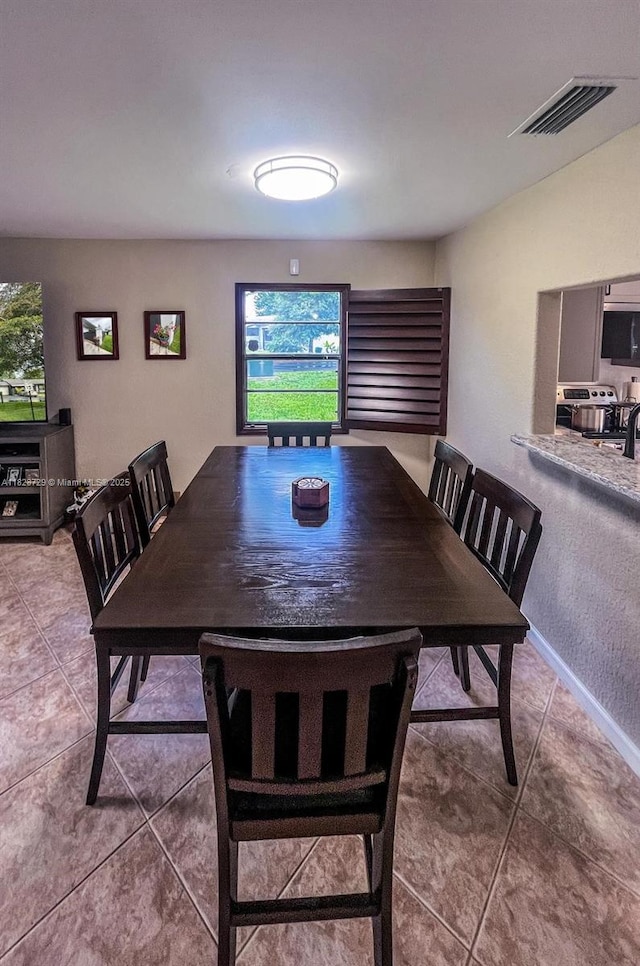 61 W Seminole Ct W, Royal Palm Beach, FL 33411 - dining room with healthy amount of natural light and tile patterned floors