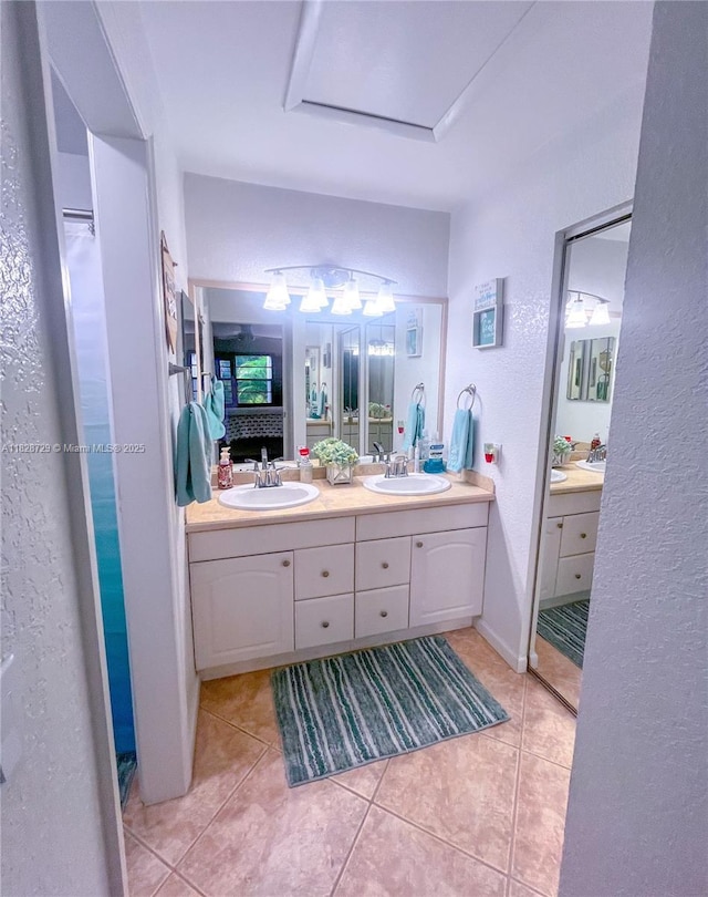 61 W Seminole Ct W, Royal Palm Beach, FL 33411 - full bath with a textured wall, double vanity, tile patterned flooring, and ensuite bath