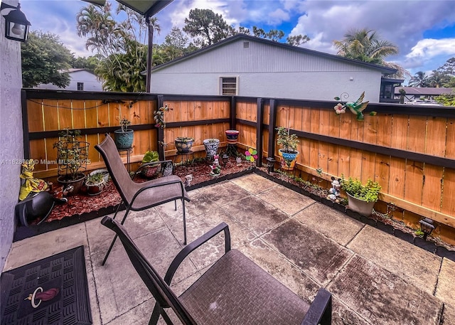 61 W Seminole Ct W, Royal Palm Beach, FL 33411 - fenced backyard featuring a patio