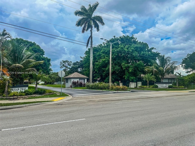 61 W Seminole Ct W, Royal Palm Beach, FL 33411 - view of asphalt street with traffic signs, sidewalks, curbs, and street lights