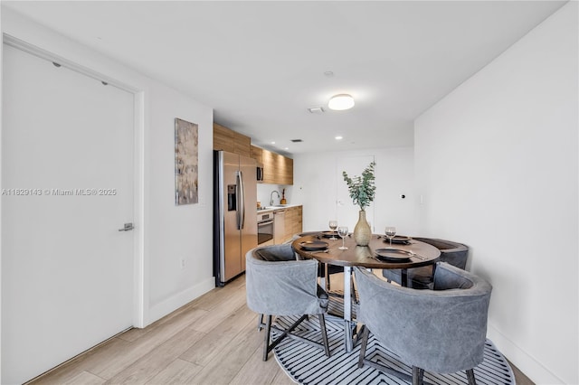 121 NE 34th St Unit 1514, Miami, FL 33137 - dining area featuring light wood-type flooring and baseboards