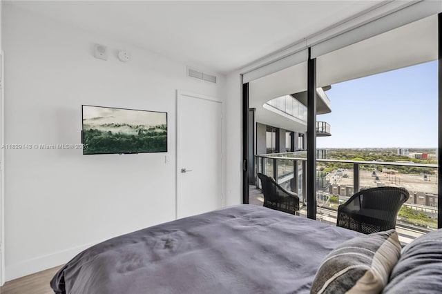 121 NE 34th St Unit 1514, Miami, FL 33137 - bedroom with wood finished floors and a wall of windows