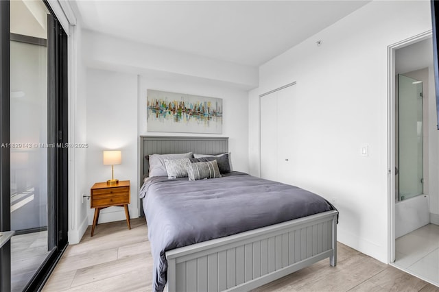 121 NE 34th St Unit 1514, Miami, FL 33137 - bedroom featuring light wood-style floors and baseboards