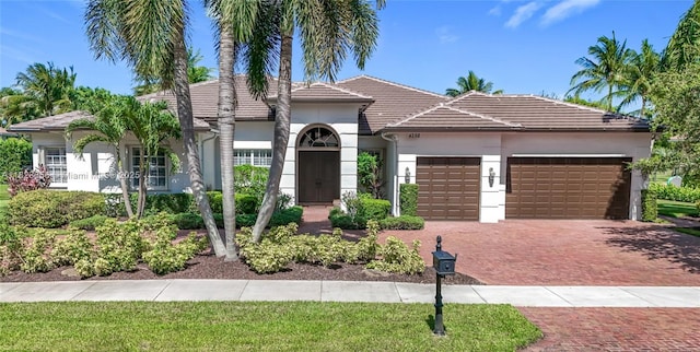 4268 SW 141st Ave, Davie, FL 33330 - view of front of house with a garage, stucco siding, decorative driveway, and a tile roof