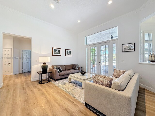 4268 SW 141st Ave, Davie, FL 33330 - living room featuring french doors, light wood finished floors, ornamental molding, and recessed lighting