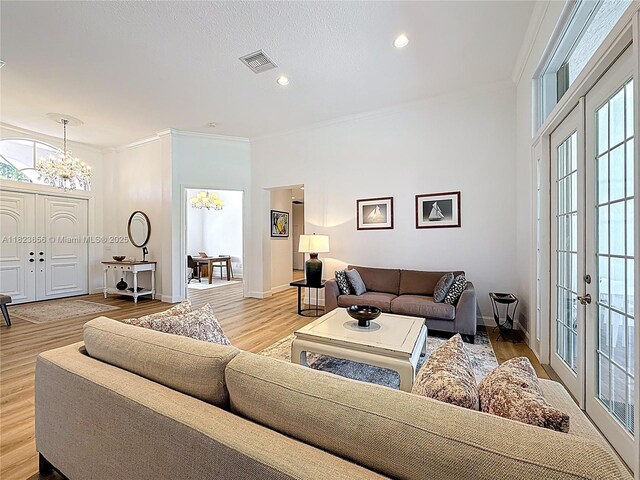 4268 SW 141st Ave, Davie, FL 33330 - living area featuring a chandelier, ornamental molding, wood finished floors, recessed lighting, and french doors