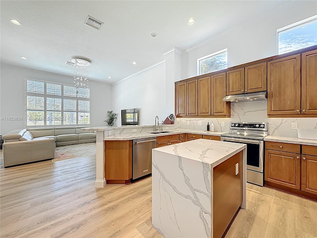 4268 SW 141st Ave, Davie, FL 33330 - kitchen featuring stainless steel appliances, under cabinet range hood, a peninsula, light wood-style flooring, and recessed lighting