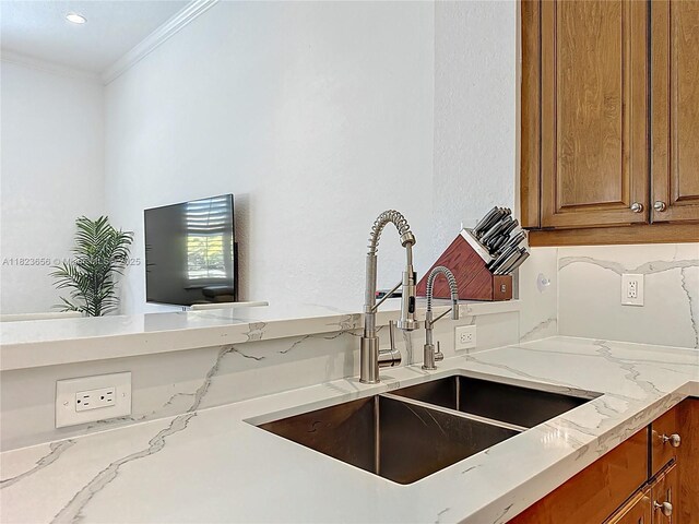 4268 SW 141st Ave, Davie, FL 33330 - kitchen with brown cabinetry, ornamental molding, light stone countertops, and recessed lighting