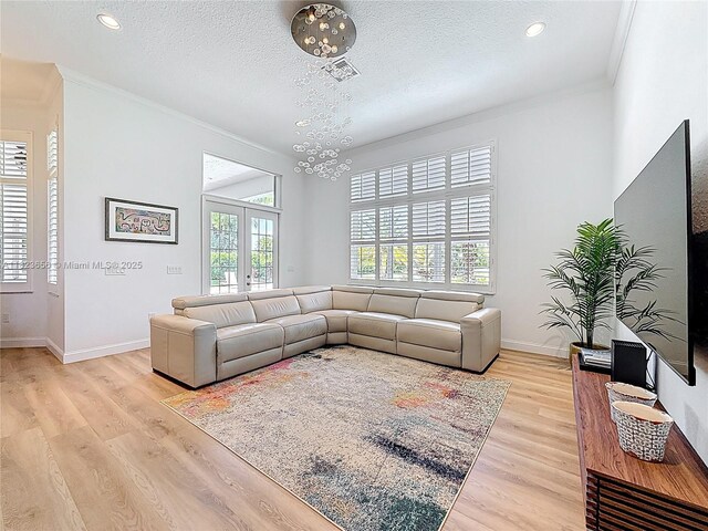 4268 SW 141st Ave, Davie, FL 33330 - living area with crown molding, light wood-style flooring, a textured ceiling, french doors, and recessed lighting